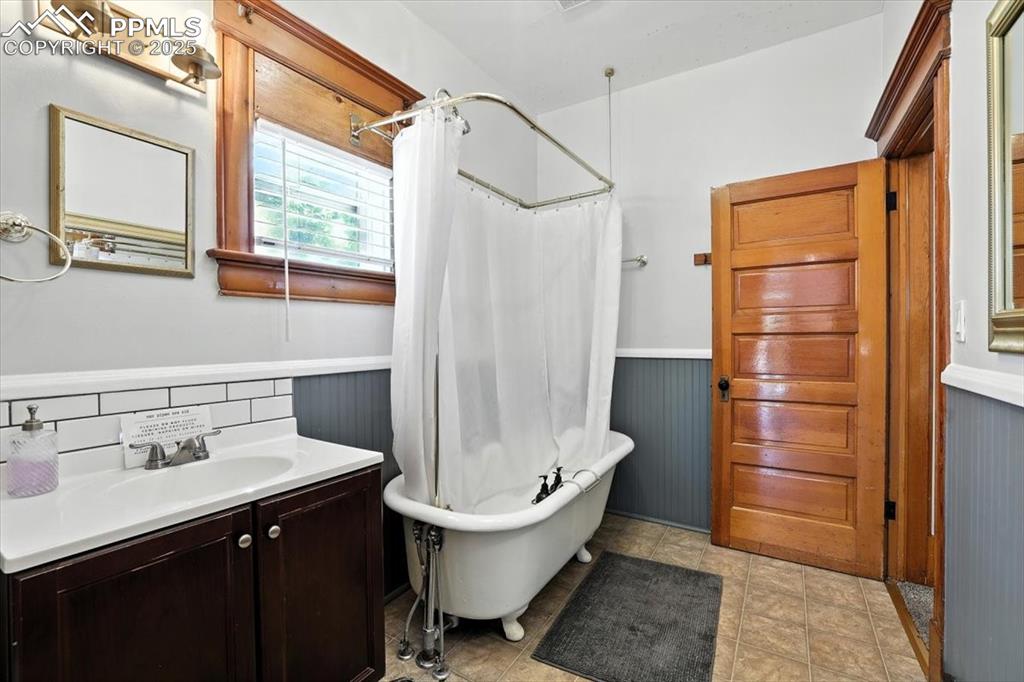 Image 30 of 48: Full bathroom with vanity, a combined bath / shower with freestanding tub, 