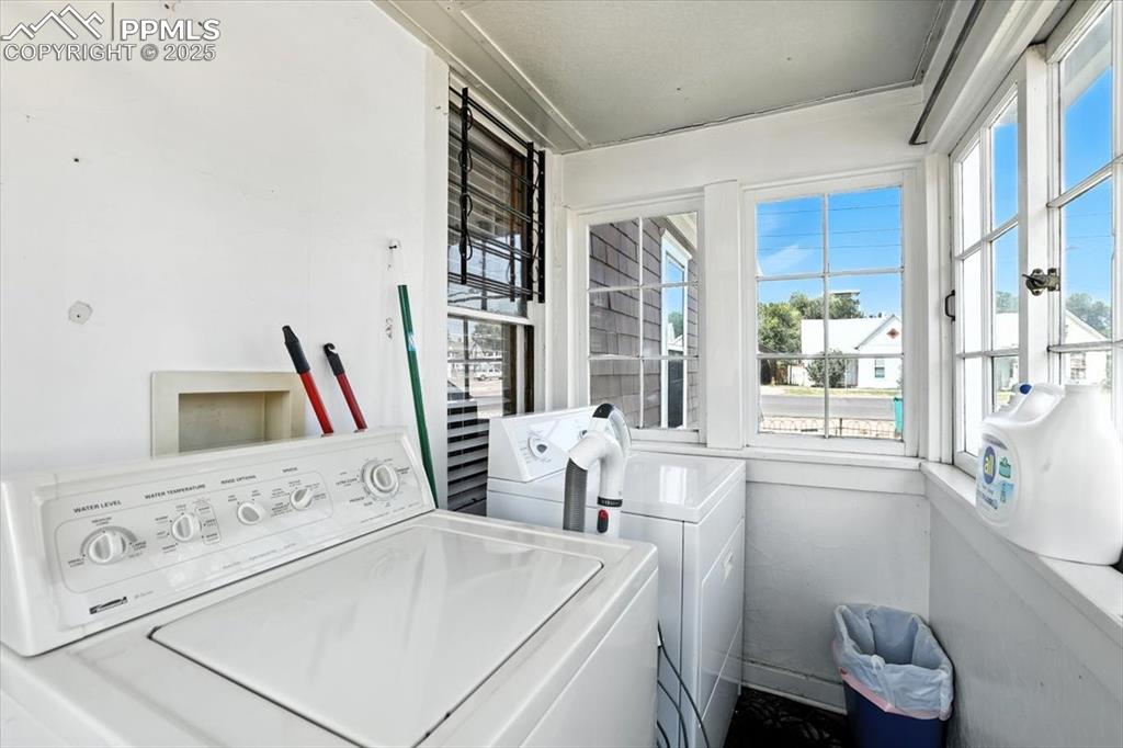 Image 33 of 48: Laundry room featuring separate washer and dryer