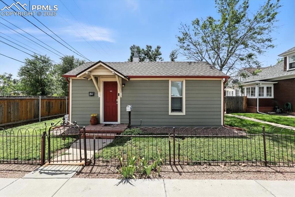 Image 35 of 48: View of front of house featuring a fenced front yard, a shingled roof, and 