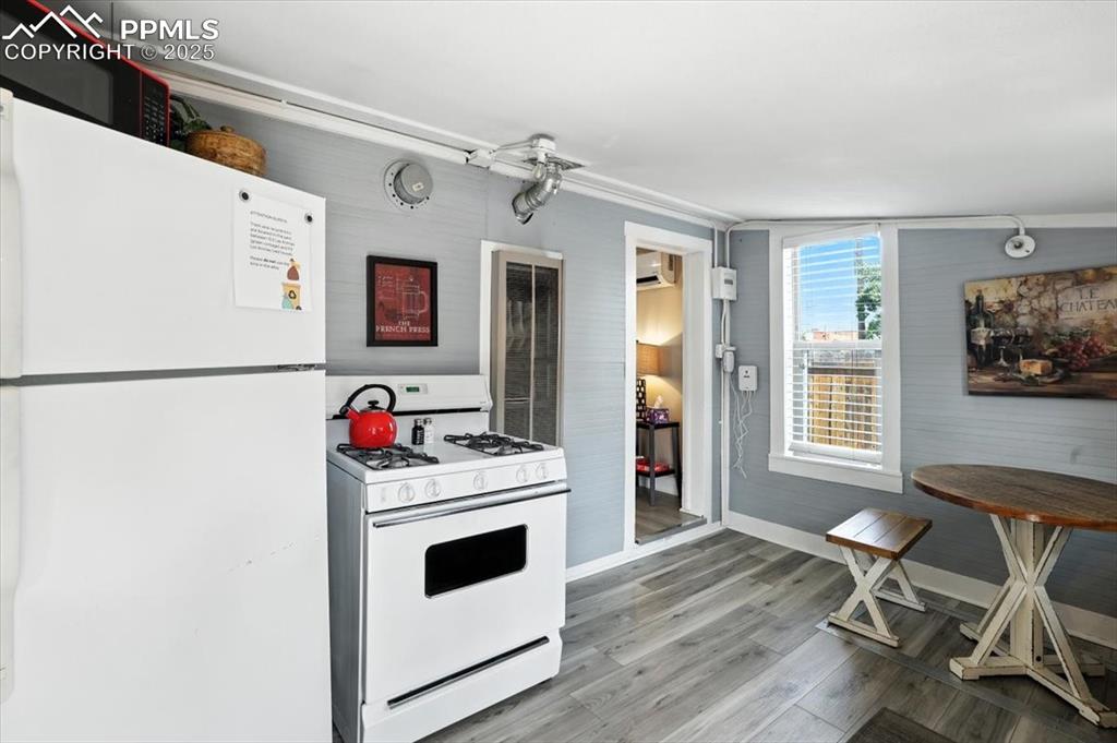 Image 41 of 48: Kitchen featuring white appliances, light wood-style floors, and a wall mou