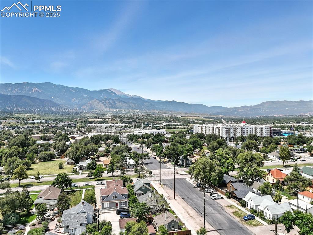 Image 47 of 48: Aerial perspective of suburban area featuring a mountain backdrop
