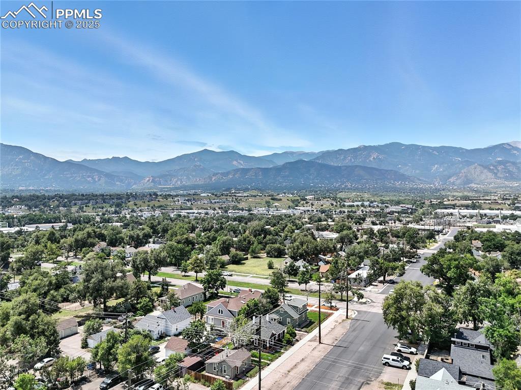Image 48 of 48: Aerial view of residential area featuring a mountainous background
