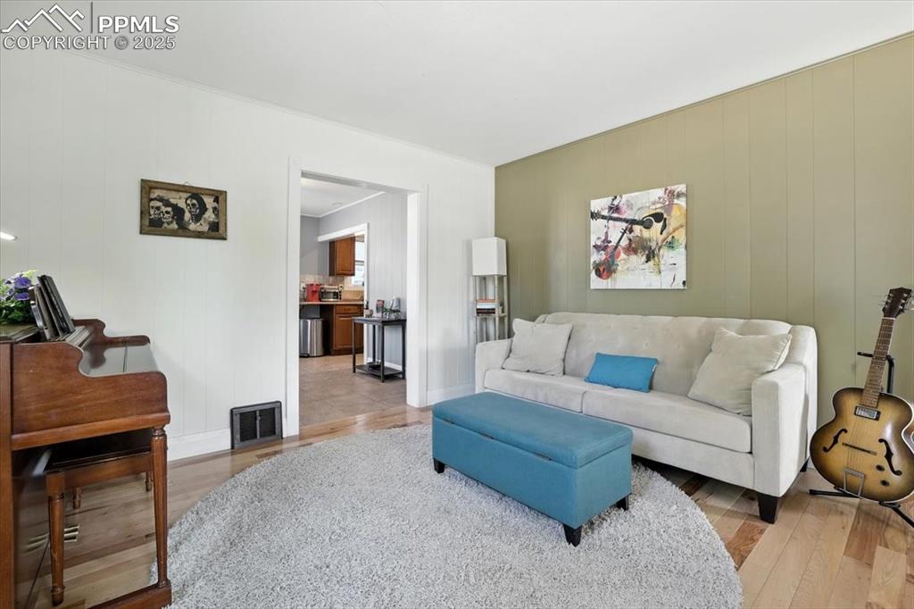 Image 9 of 48: Living area featuring wood finished floors and wooden walls
