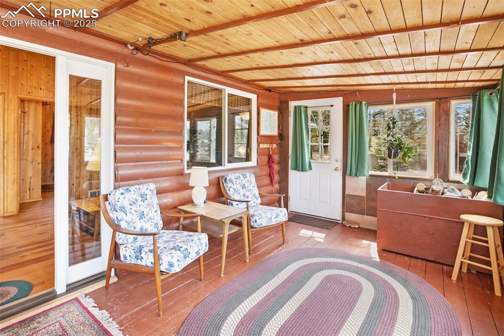 Image 12 of 38: Sunroom / solarium featuring beamed ceiling