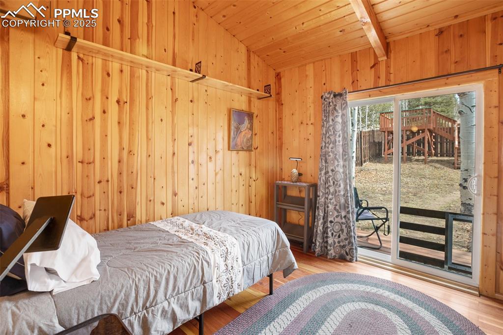 Image 16 of 38: Bedroom with sliding glass door to fenced back yard.