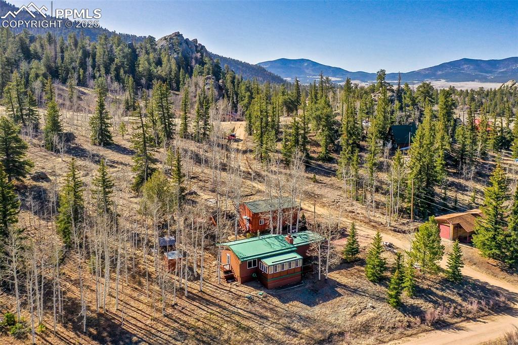 Image 30 of 38: Aerial view with a wooded view and a mountain view