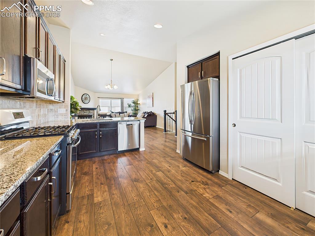 Image 16 of 50: Gourmet kitchen featuring granite countertops, stainless steel appliances, 