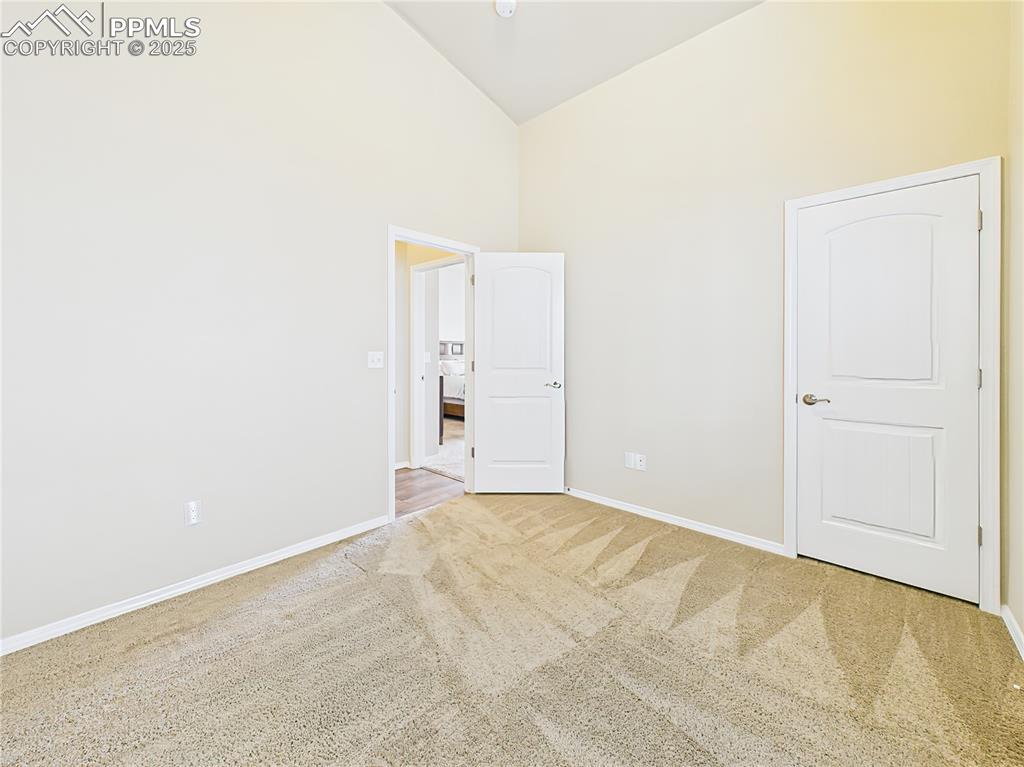 Image 23 of 50: 2nd main level bedroom Vaulted ceiling and neutral palette offer a versatil