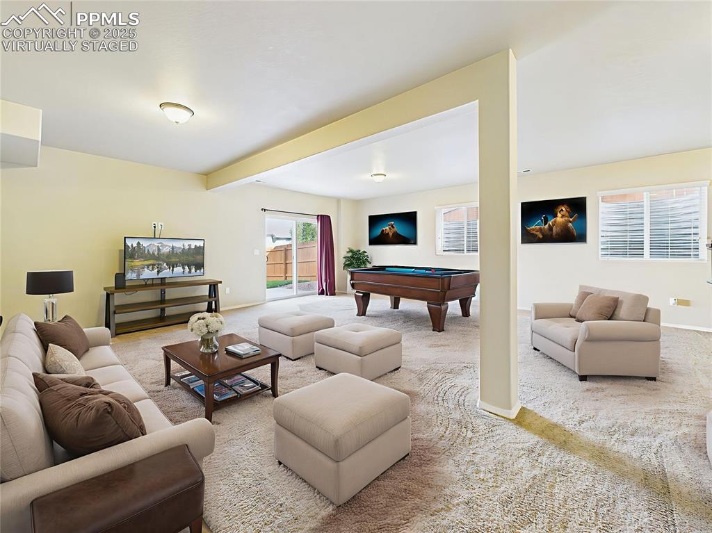 Image 28 of 50: Virtually Staged – Flexible recreation space shown as a game and media room