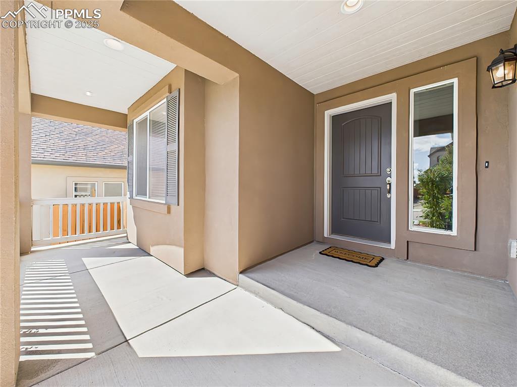 Image 3 of 50: The covered entry is accented with a sidelight window and updated exterior 