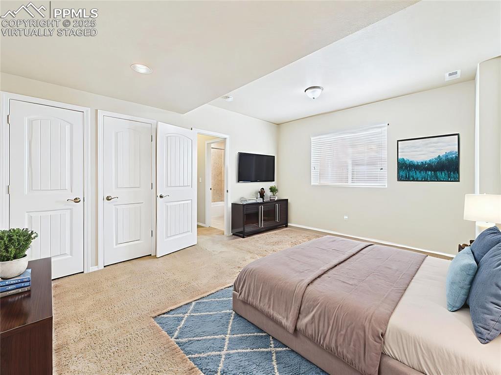 Image 37 of 50: Virtually Staged – Spacious lower-level bedroom shown furnished for comfort