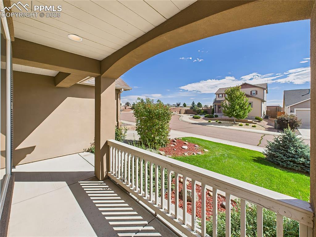 Image 4 of 50: Covered front porch overlooks a peaceful cul-de-sac setting and offers a pe