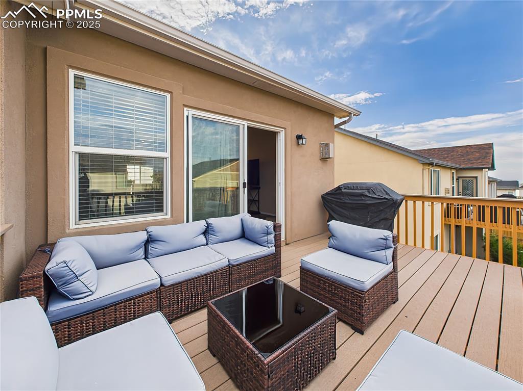 Image 43 of 50: Elevated deck with space for outdoor seating and grilling.