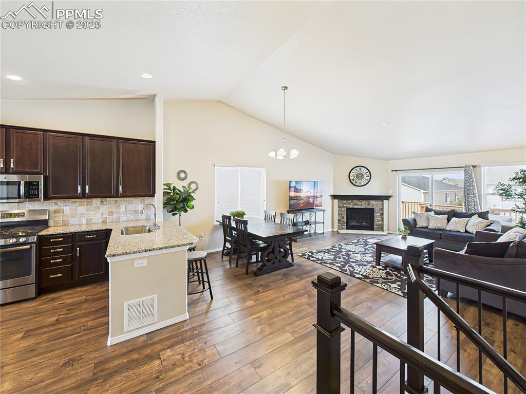 Image 6 of 50: Elegant wood laminate flooring leads into the open-concept main level with 