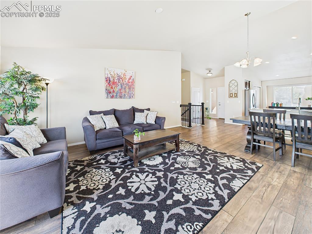 Image 9 of 50: Ample natural light pours in through large windows, highlighting the open l