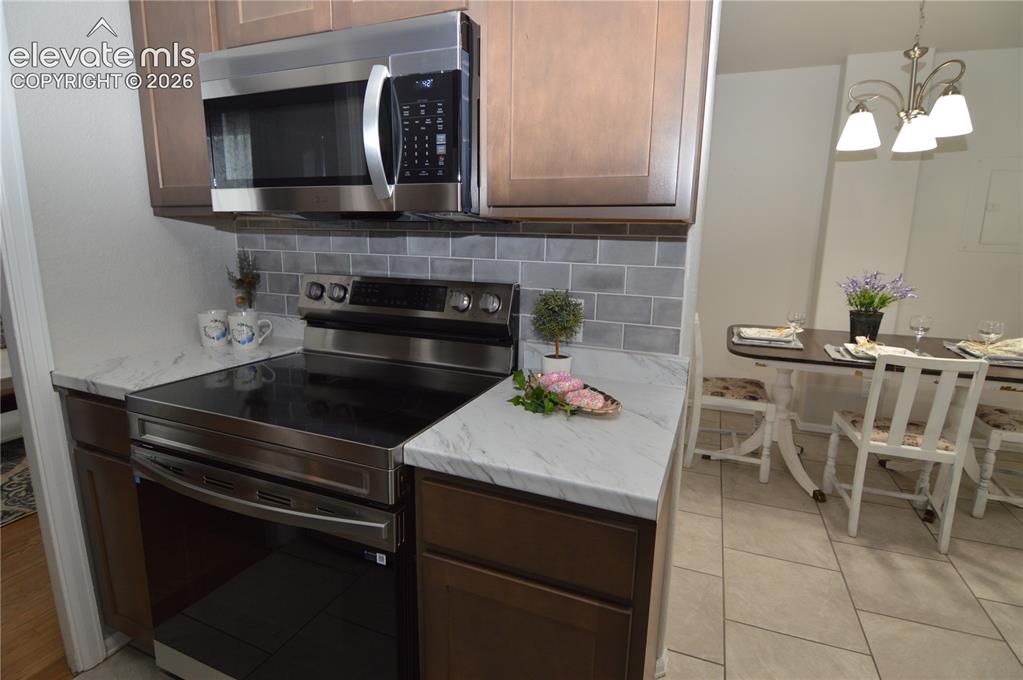 Image 10 of 23: The dining room is just off the kitchen. 