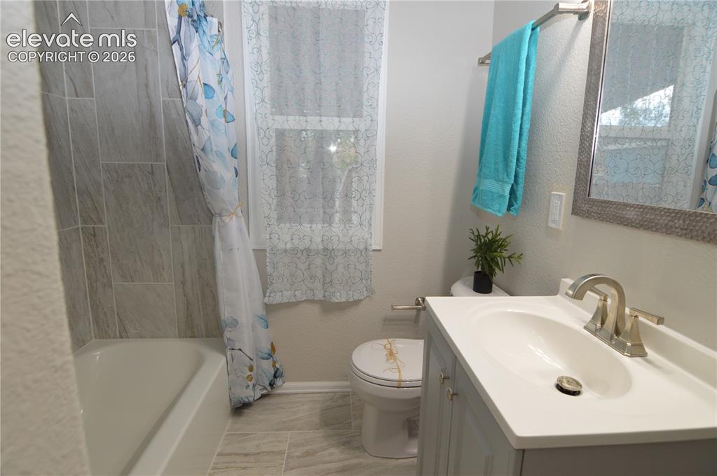 Image 14 of 23: Bright and cheery bathroom.