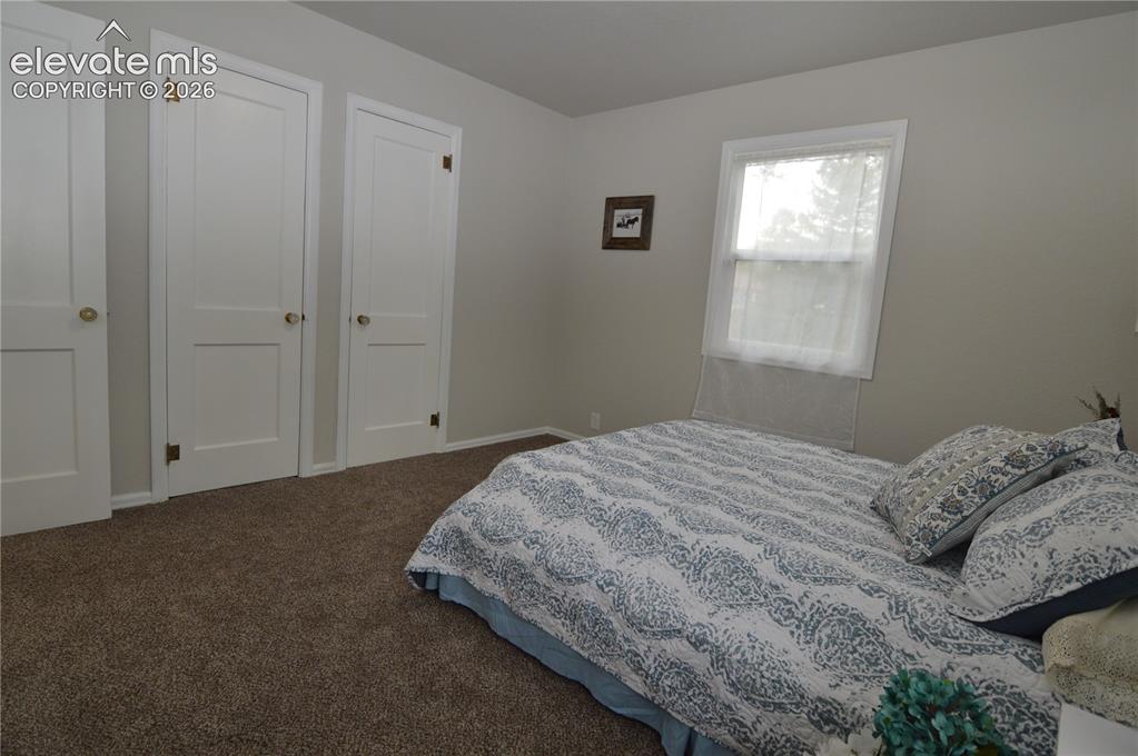 Image 16 of 23: The primary bedroom has 2 closets with original doors and hardware.