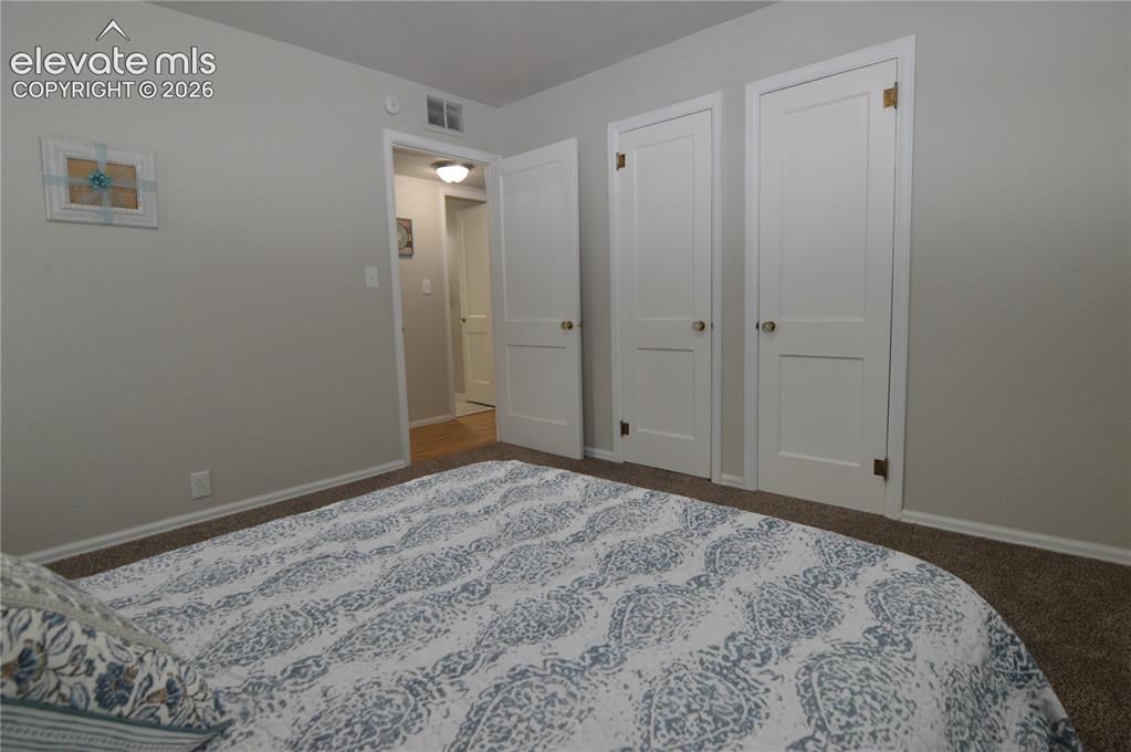 Image 17 of 23: A look into the hallway from the primary bedroom.