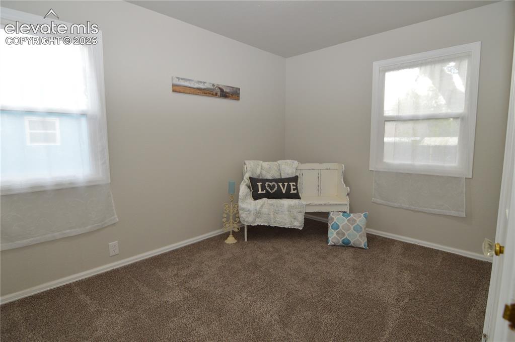 Image 18 of 23: The secondary bedroom  with lots of natural light.