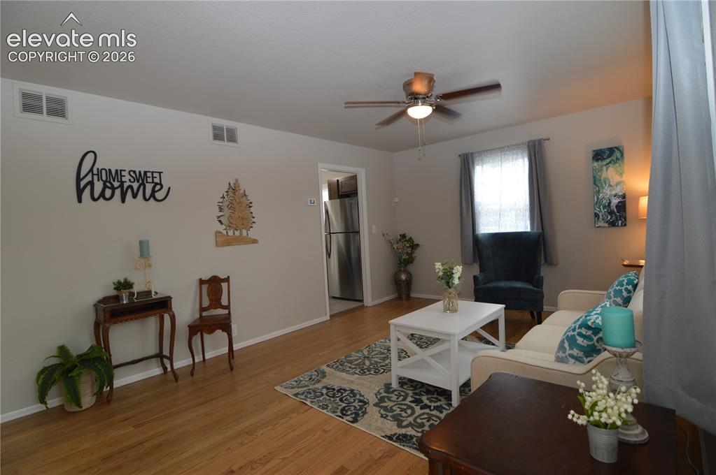 Image 2 of 23: Just inside the front door..gleaming hardwood floors welcome you.