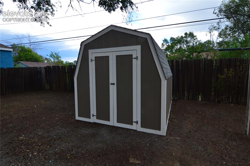 Image 21 of 23: Plenty of storage space in this shed for your yard items. 