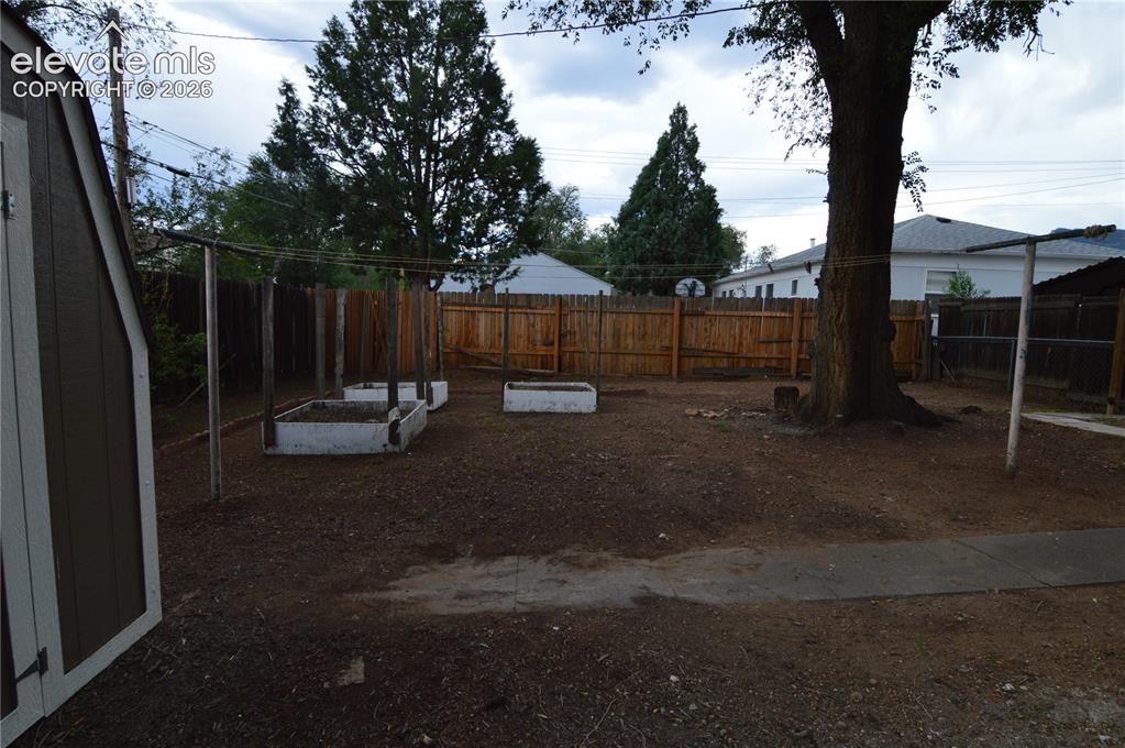 Image 23 of 23: Raised garden beds for planting a garden. And a energy efficient "dryer" (c