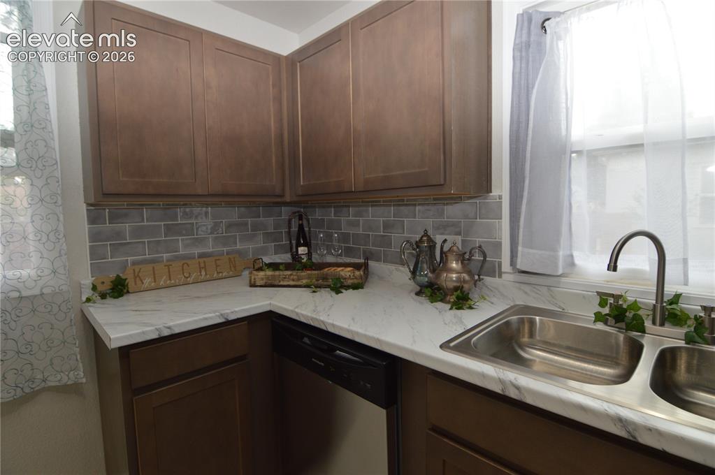 Image 9 of 23: The custom tile backsplash really adds to the kitchen.