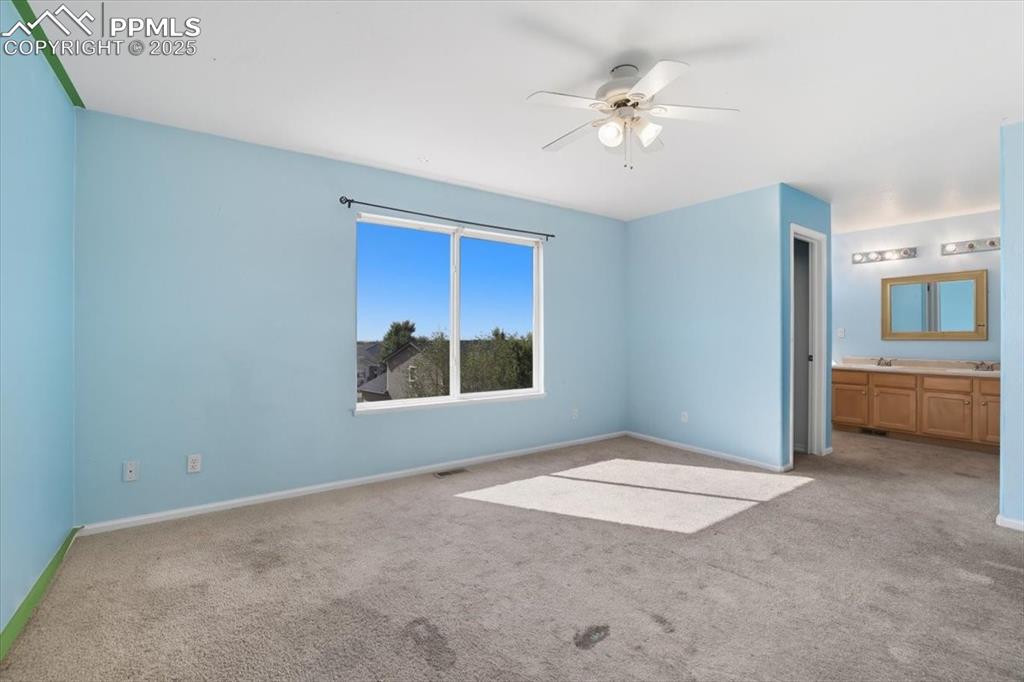 Image 19 of 44: Primary bedroom with attached bathroom.