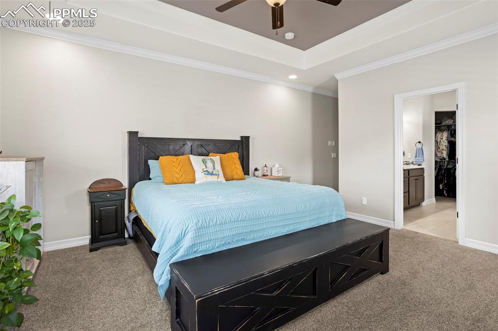Image 14 of 47: Bedroom with light carpet, recessed lighting, a raised ceiling, and baseboa