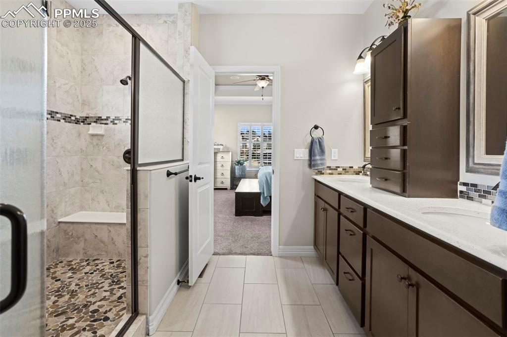Image 16 of 47: Ensuite bathroom featuring a shower stall, connected bathroom, a ceiling fa