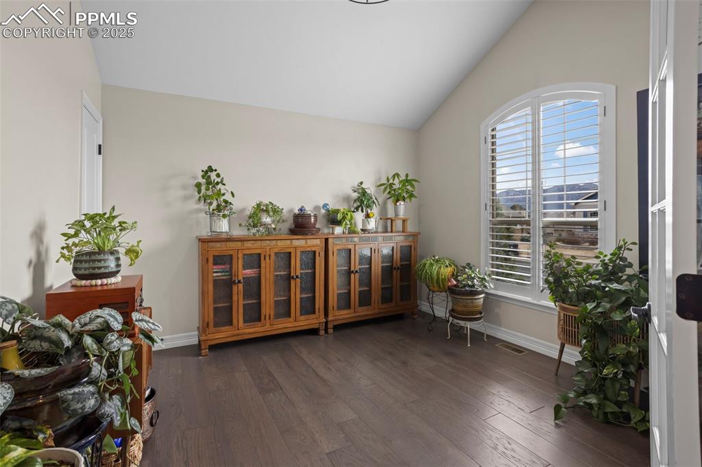 Image 17 of 47: Sitting room featuring lofted ceiling, visible vents, dark wood-style floor