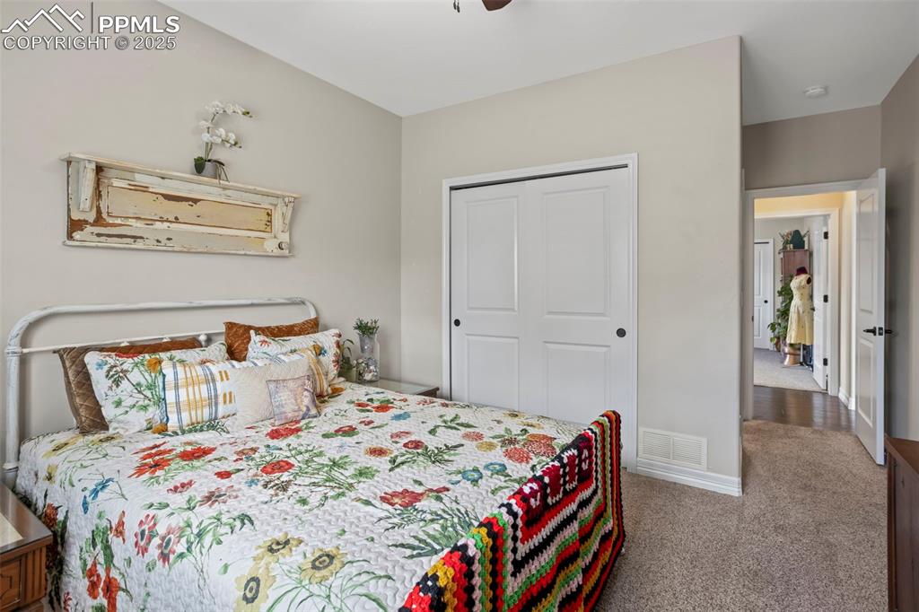 Image 20 of 47: Bedroom with a ceiling fan, baseboards, visible vents, a closet, and carpet