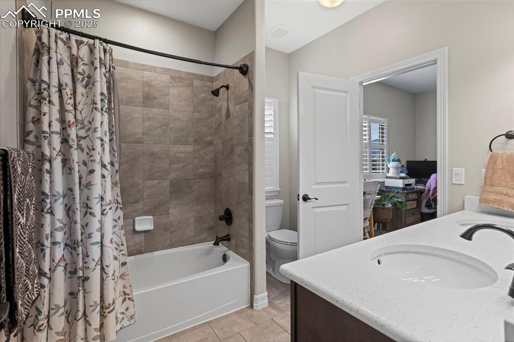 Image 21 of 47: Full bathroom with tile patterned flooring, visible vents, toilet, vanity,