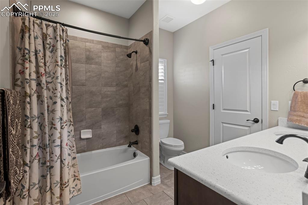 Image 22 of 47: Full bath with tile patterned floors, visible vents, toilet, shower / bath