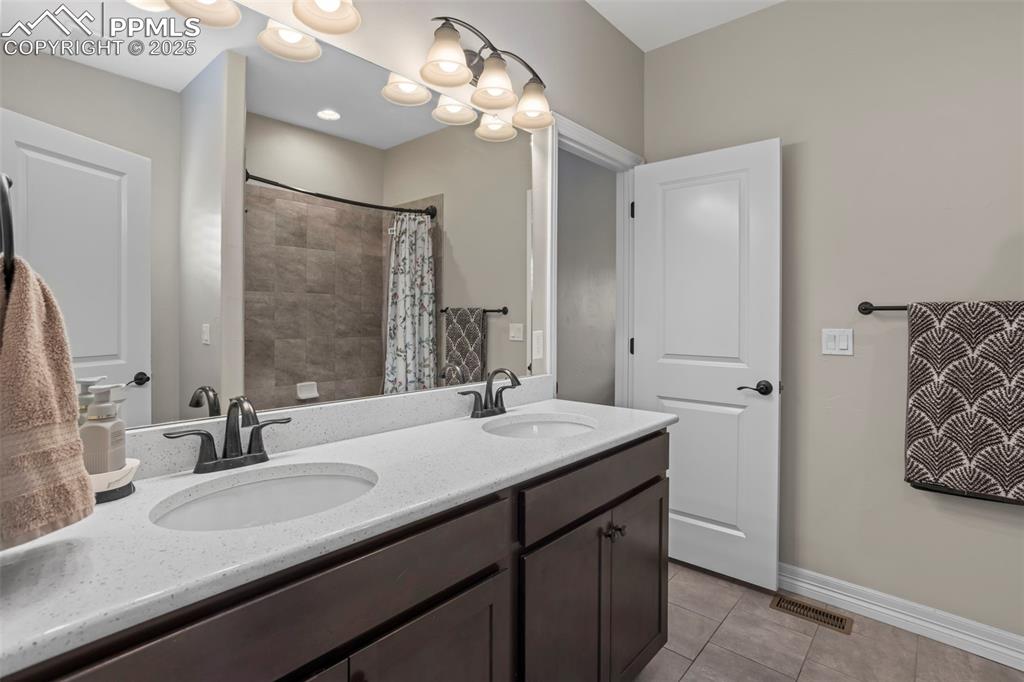 Image 23 of 47: Bathroom featuring tile patterned floors, baseboards, visible vents, and a