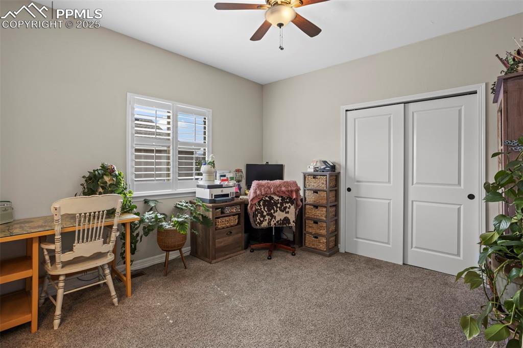 Image 24 of 47: Home office featuring ceiling fan and carpet flooring