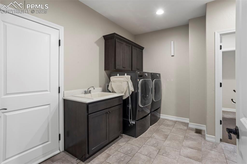 Image 26 of 47: Laundry area featuring visible vents, a sink, washing machine and dryer, ca