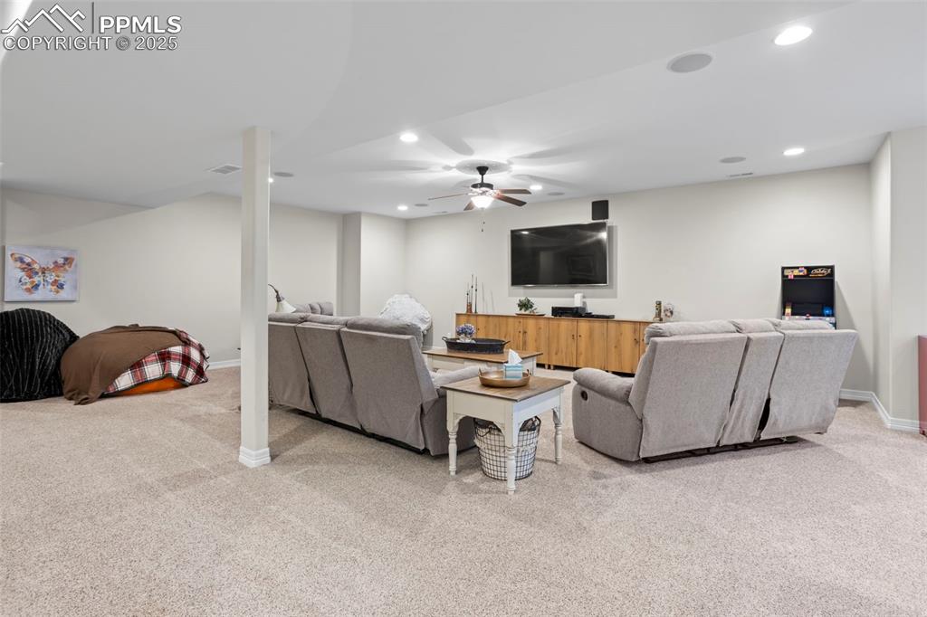 Image 28 of 47: Living area with visible vents, recessed lighting, baseboards, and carpet f