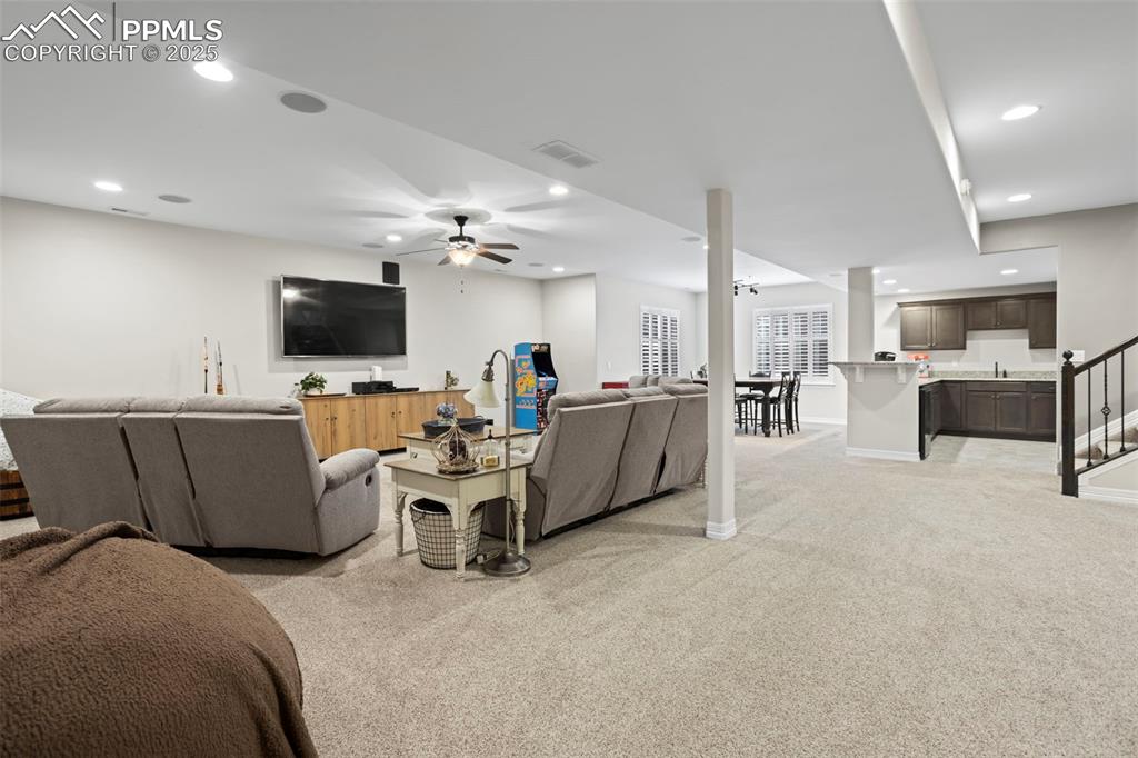 Image 32 of 47: Living room featuring visible vents, baseboards, light carpet, recessed lig