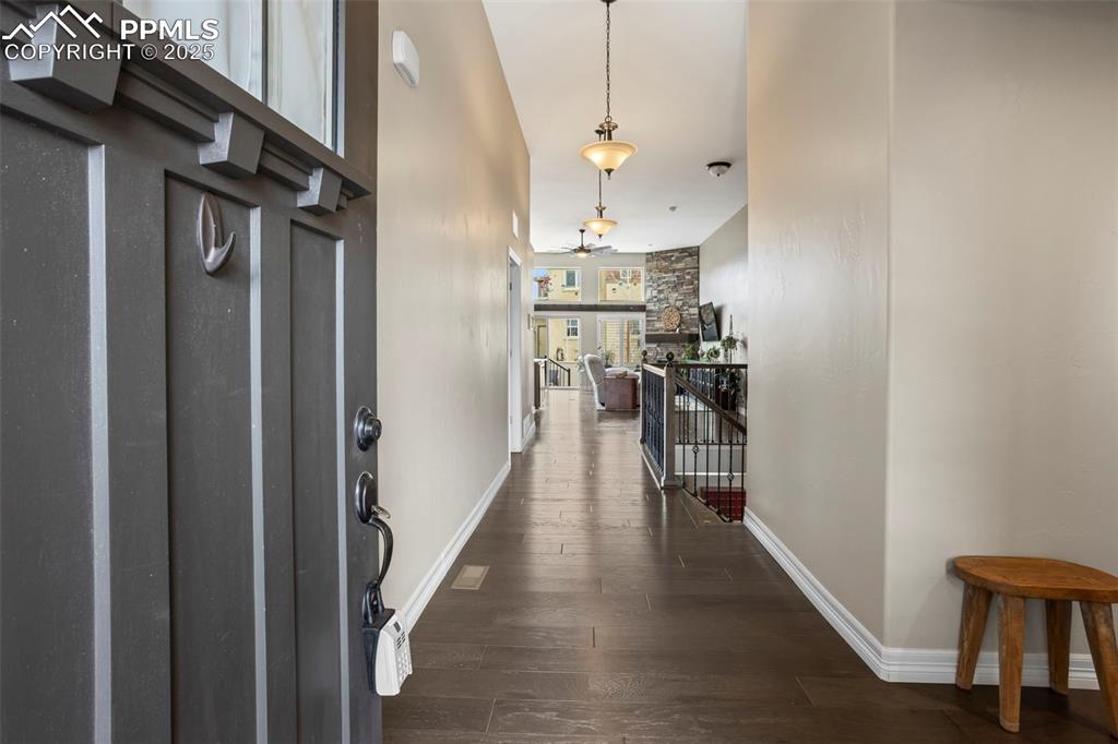 Image 4 of 47: Foyer featuring ceiling fan, baseboards, and wood finished floors