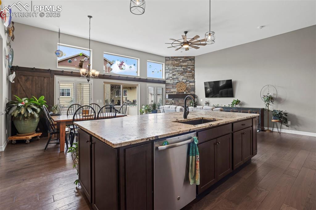 Image 9 of 47: Kitchen featuring a sink, dishwasher, a ceiling fan, and dark brown cabinet