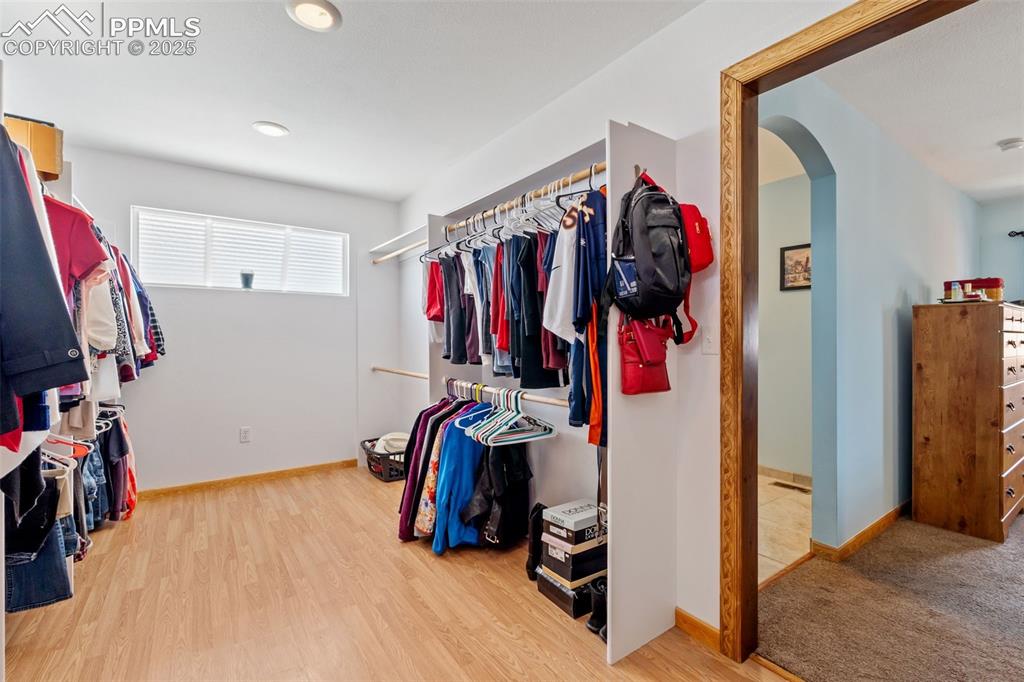 Image 10 of 38: Massive walk-in closet with built-in organization