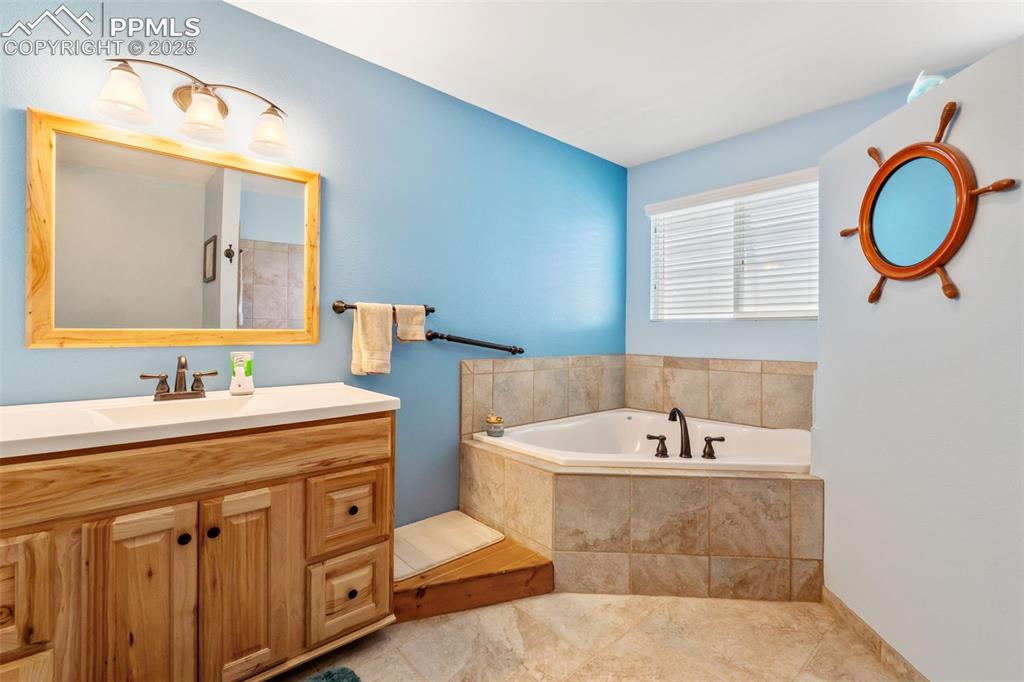 Image 11 of 38: Spa-style master bath with soaking tub