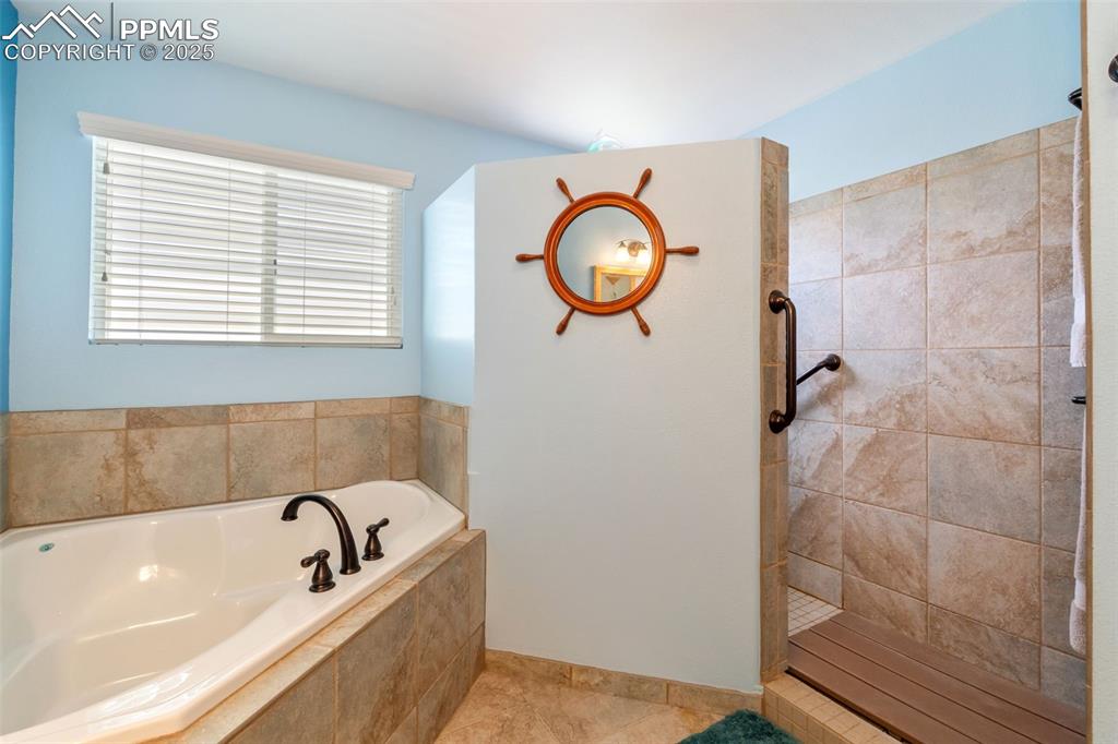 Image 13 of 38: Luxury tiled walk-in shower with modern finishes