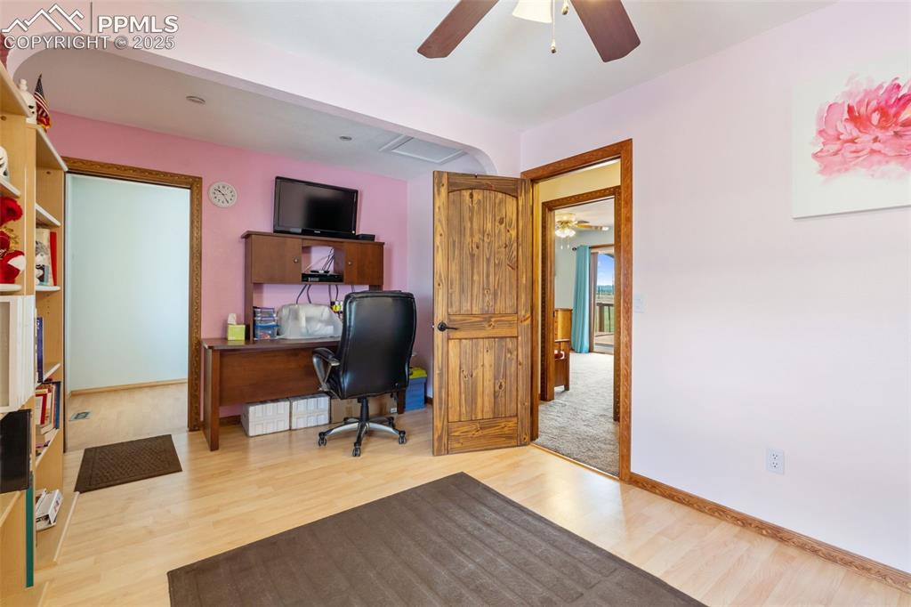 Image 15 of 38: Spacious secondary upper bedroom with ceiling fan and natural light