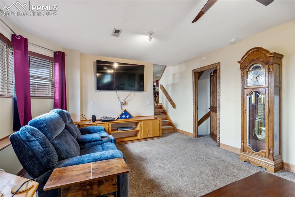 Image 20 of 38: Cozy lower-level family room with entertainment space