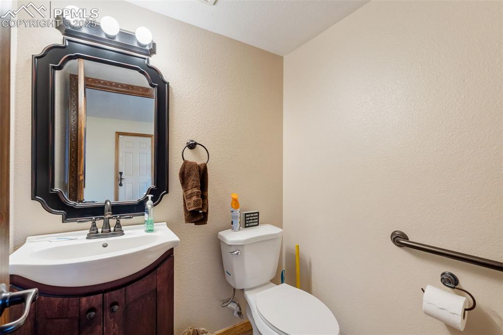 Image 25 of 38: Updated half bathroom in lower-level.