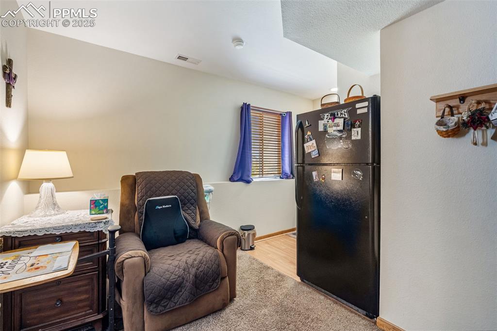 Image 26 of 38: Cozy sitting area with kitchenette in suite