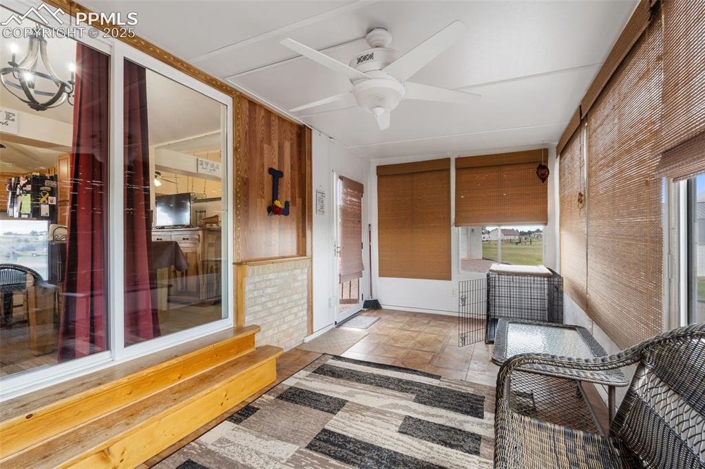 Image 3 of 38: Bright sunroom perfect for year-round relaxation
